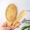 A narrow bamboo comb with precision-spaced teeth.