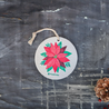 Close up photo of the limited edition holiday poinsettia pop up sponge.