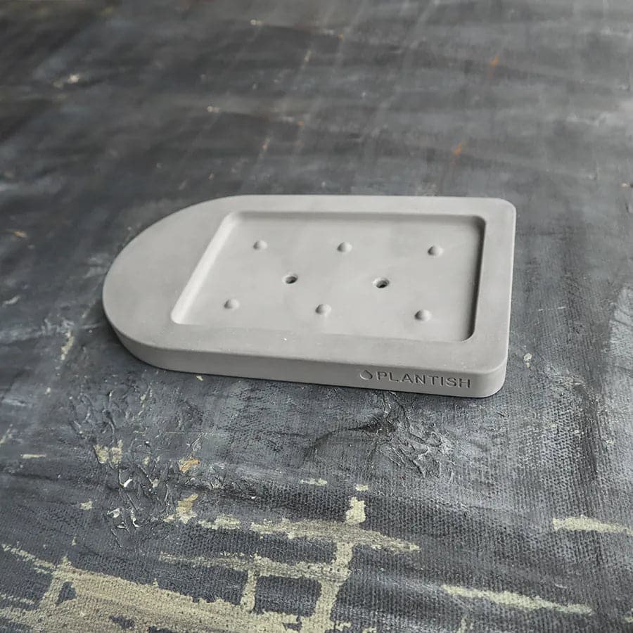 Side view of our versatile and polished grey self-drying soap dish with holes, perfect for any bathroom.