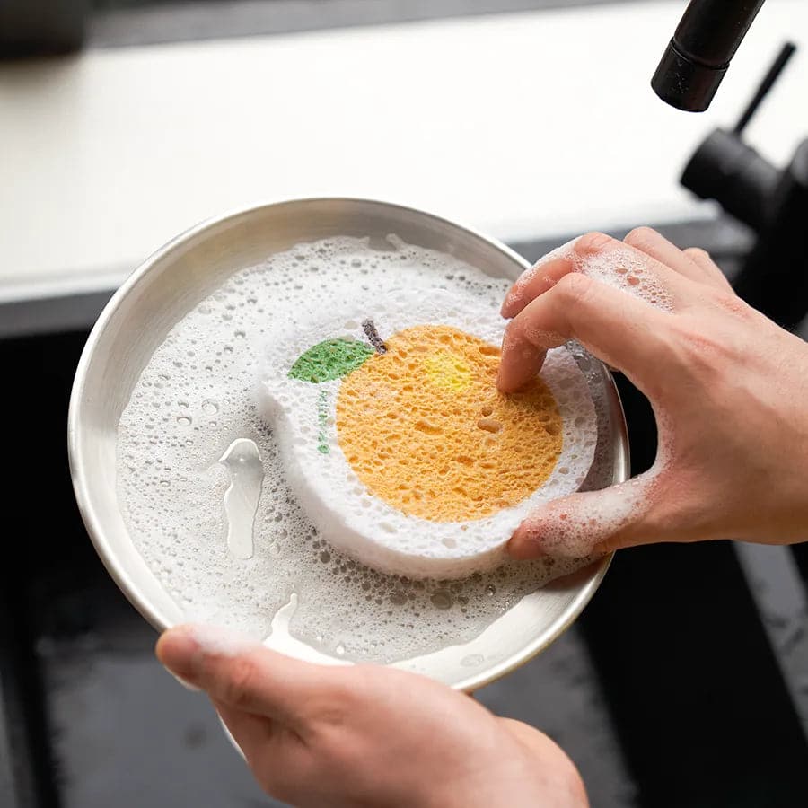Orange pop-up sponge cleaning pan with soap. Eco-friendly kitchen cleaning alternative and plastic-free kitchen sponge.