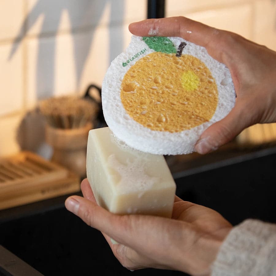 Using orange pop up sponge with solid dish soap brick. Zero waste and multi-use kitchen cleaning tool.