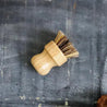 The Sisal & Palm Pot Scrubber with a bamboo handle is a sustainable and effective tool for cleaning pots, pans, and other cookware. This scrubber combines natural materials and ergonomic design for optimal performance.