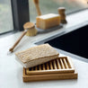 Non-toxic, organic cotton Eco-friendly sponge made of loofah on top of a dual-layer bamboo soap dish.