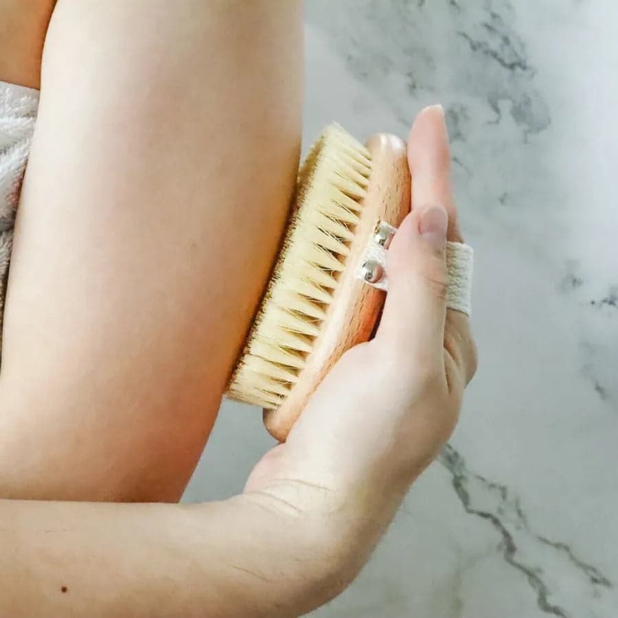 Best exfoliating body brush for cellulite and stimulating blood circulation. Using eco friendly body brush on arm.