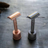 Eco friendly and plastic free rose gold and metallic black safety razor kit with matching holders.