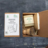 Solid dish soap bar, loofah eco sponge and sisal and palm pot scrubber in box. Zero waste packaging.