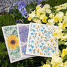 Set of 3 floral bursts reusable dishcloths in field of flowers.