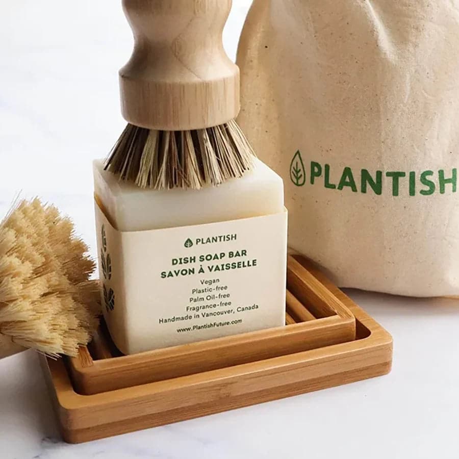 Zero waste and unscented solid dish soap bar with sisal and palm pot scrubber on top.