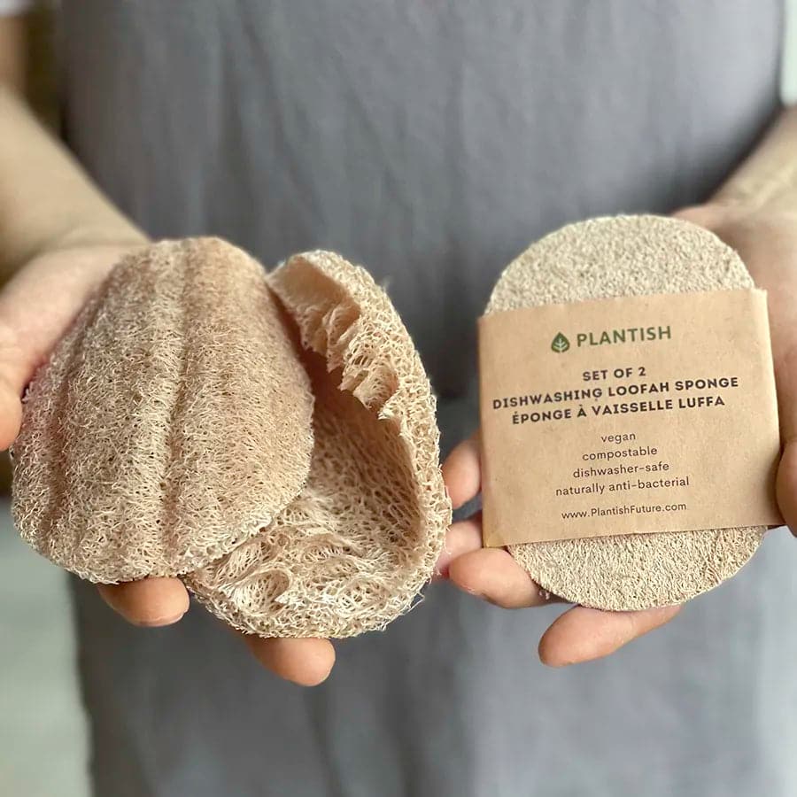 Hands holding set of 2 loofah dishwashing sponges. Plastic free and eco friendly.