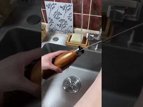 Video using sisal bottle brush to clean steel water bottle.