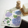 Hydrangea reusable dishcloth with sisal and palm pot scrubber and solid dish soap bar.
