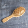 Bamboo-based brush designed with wooden bristles to effectively detangle and smoothen your hair.