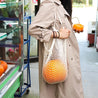 Our reusable organic cotton net tote bag carrying a large item; pumpkin.