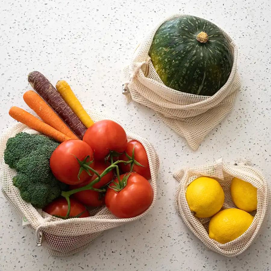 Fresh produce stored in plastic free organic cotton mesh bags with drawstring.