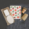 Peach Swedish sponge cloth with loofah sponge, loofah pad, solid dish soap brick and sisal and palm pot scrubber.