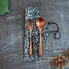 Wooden cutlery kit with cloth cover.