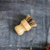 Sisal and palm pot scrubber with natural bamboo handle.