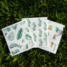 Set of 3 reusable dishcloths laying on grass. Eco friendly and plastic free.