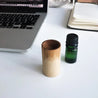 Wooden circular travel diffuser absorbing essential oils and diffusing it into the air.